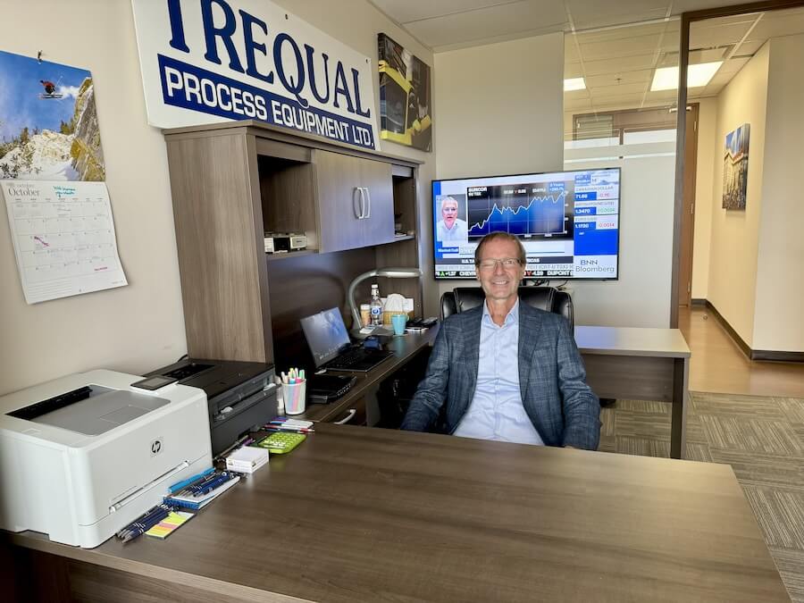 Milan sitting behind the desk